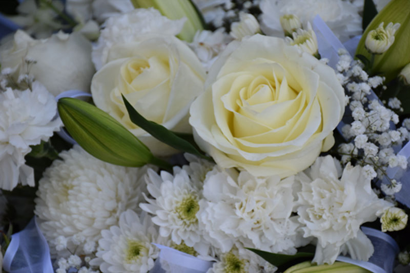 Memorial flower arrangement featuring white blooms